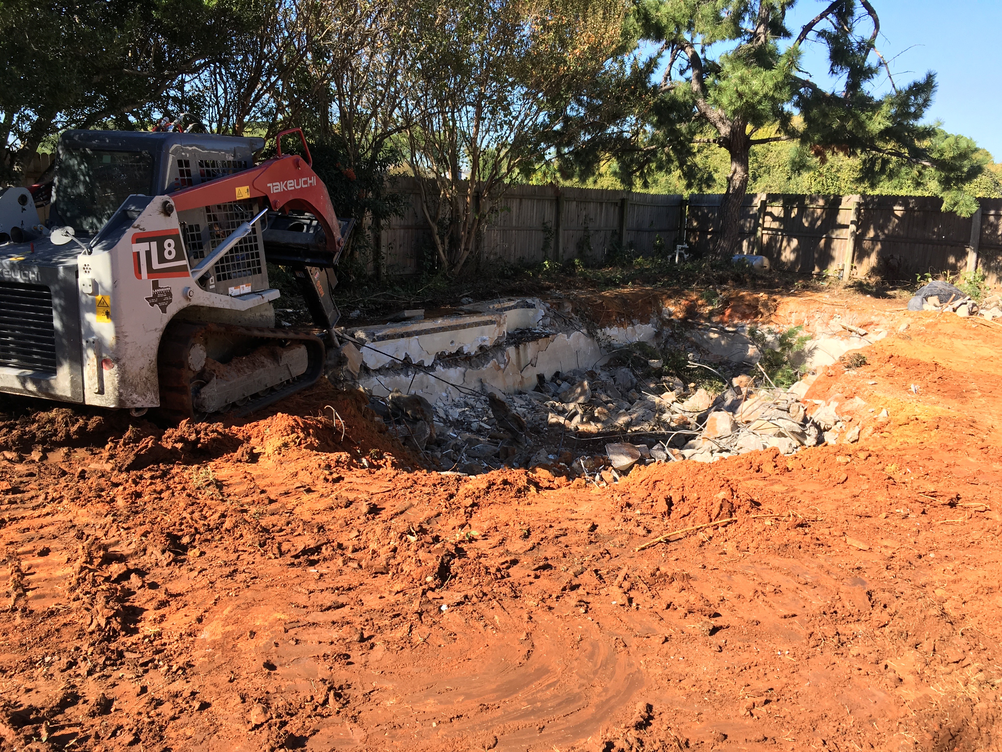 A person on a construction site with a tractor.