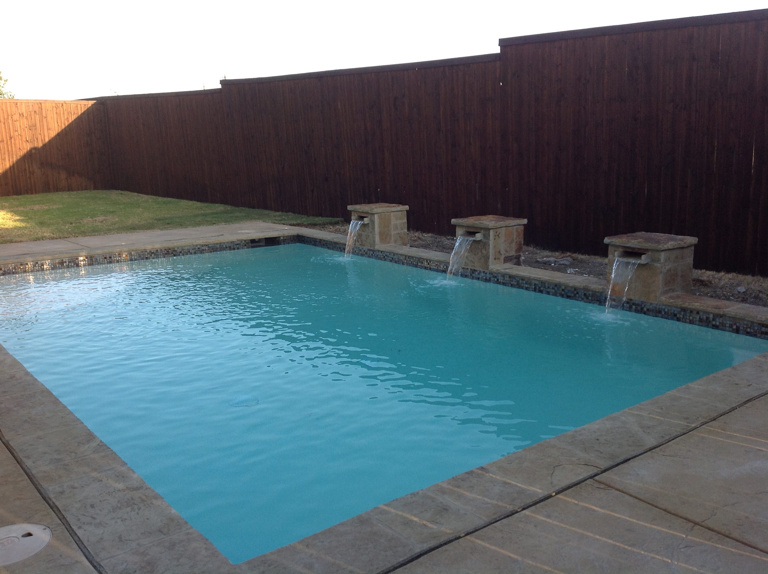 A pool with water jets coming out of it.